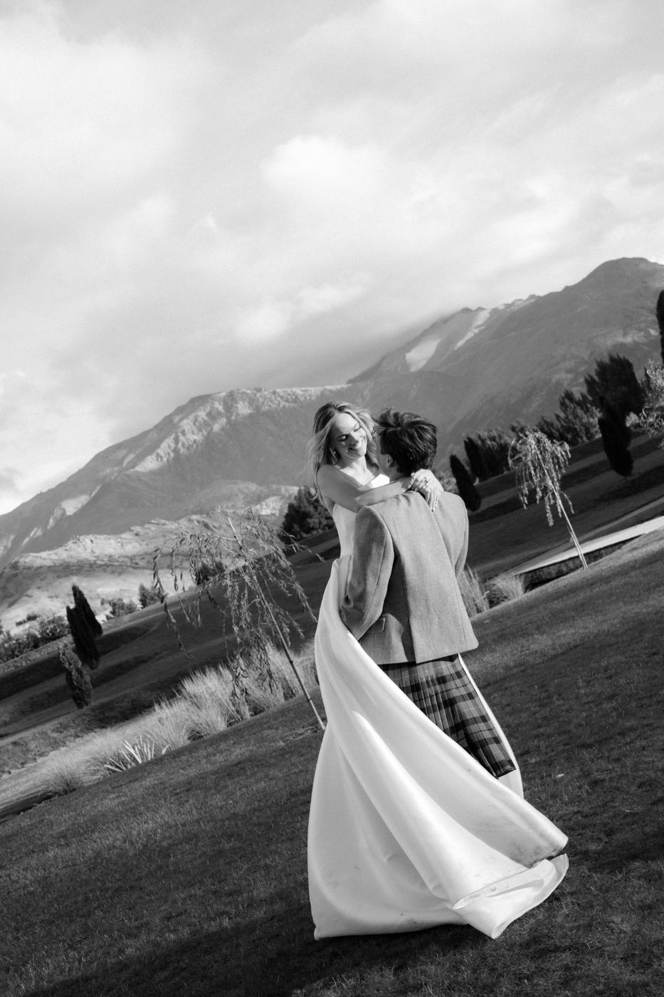 Couple dancing with mountains behind them