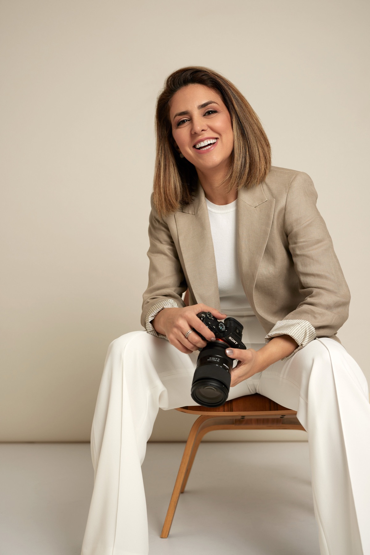 Ellie Kia, wedding photographer, smiling with her camera
