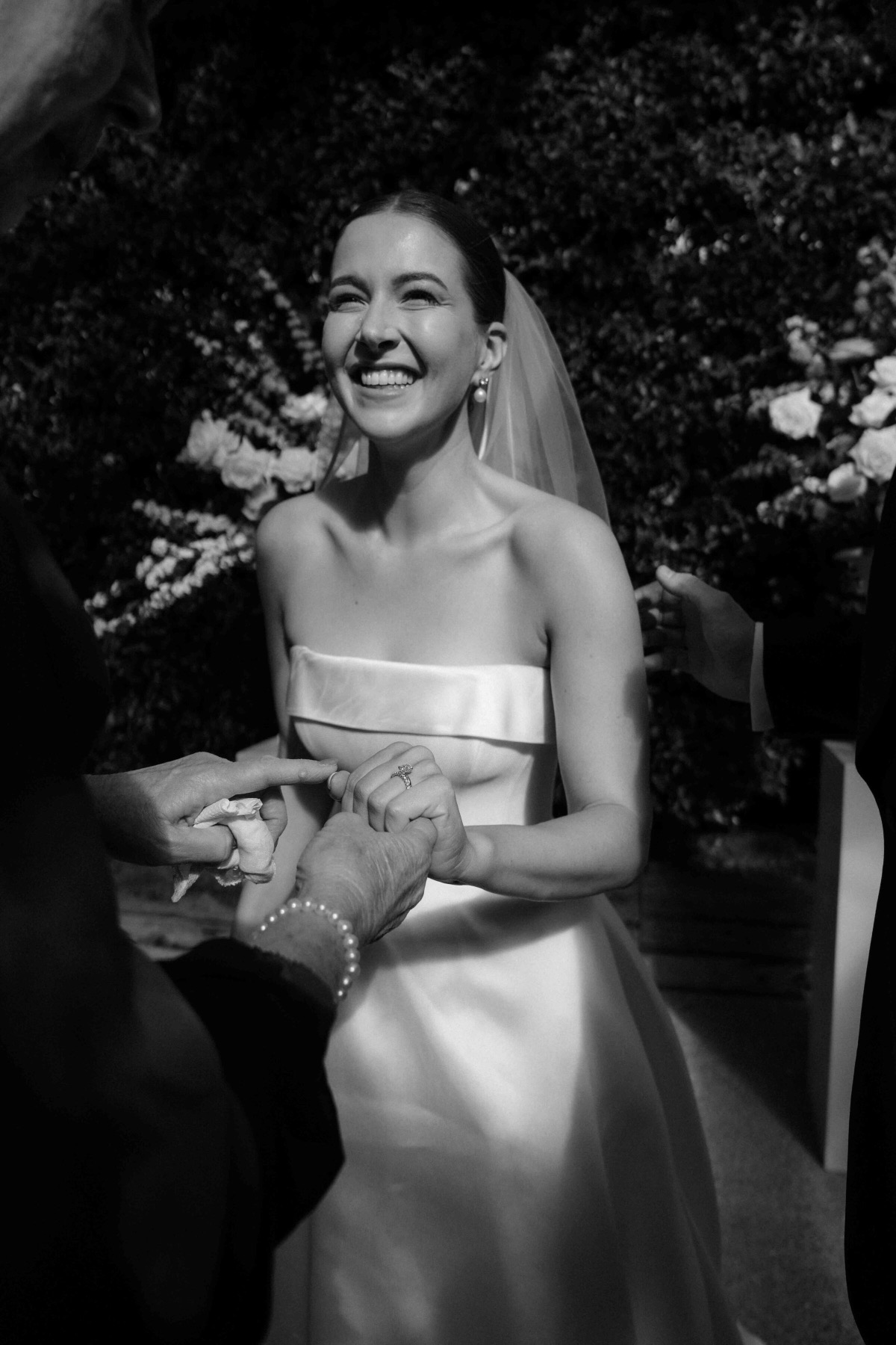 Bride laughing as the ring goes on