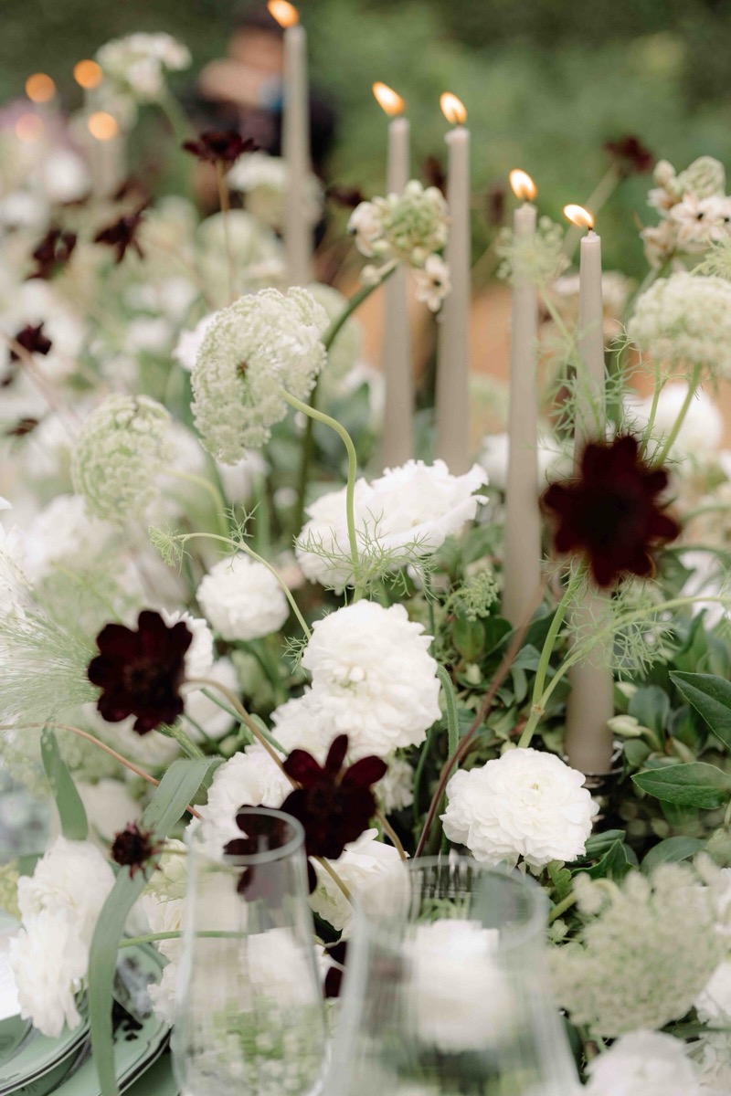 Candlelit table florals in white and burgundy